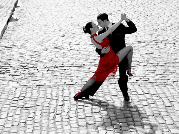 Couple dancing Tango on cobblestone road
